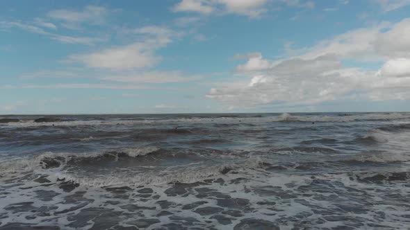 Drone flying over of big waves in Shekvetili sand beach alt