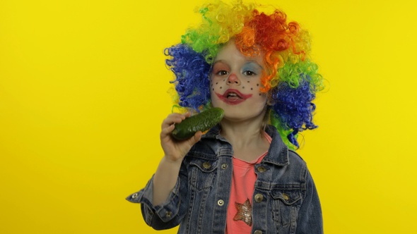 Little Child Girl Clown in Colorful Wig Making Silly Faces, Singing, Smiling, Dancing. Halloween alt