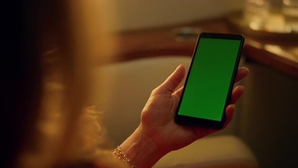 Closeup Hand Holding Smartphone in Luxury Cabin alt