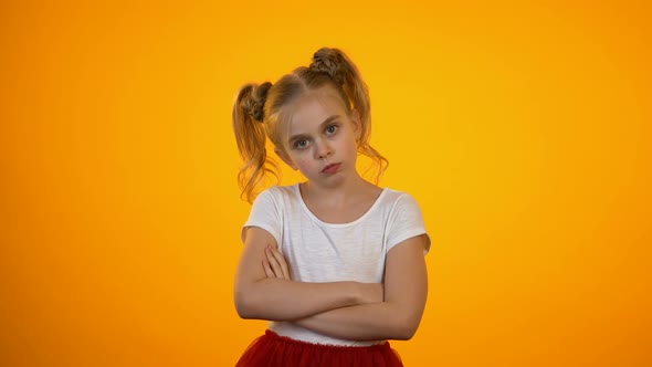 Naughty Preteen Girl Frowning and Crossing Hands, Turning Away, Enfant Terrible alt