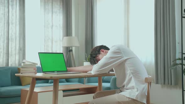 Side View Of Asian Man Student Sleeping While Using Green Screen Computer At Home alt