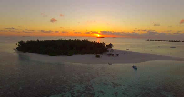 Aerial drone view of a scenic tropical island in the Maldives at sunset alt