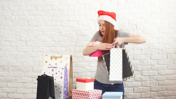 Young Shopaholic Girl Is Picking Up Christmas Boxes alt
