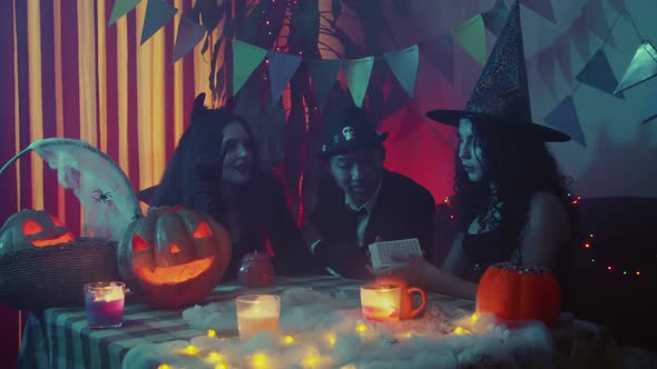 A Group of Friends is Guessing on Cards on Halloween alt