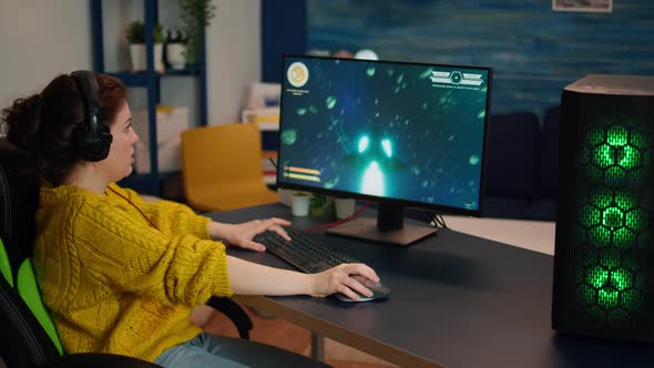 Focused Woman Gamer Wirh Headset Playing Shooter Online Video Game alt
