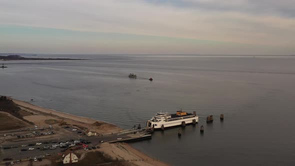 an aerial shot of an Orient Point ferry as it takes on vehicles and passengers. It was a cloudy day alt