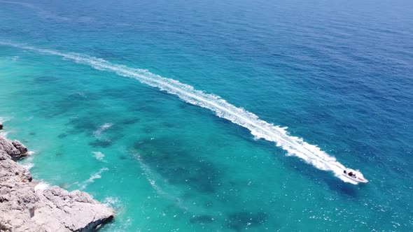 Drone View of a Boat the Blue Clear Waters alt