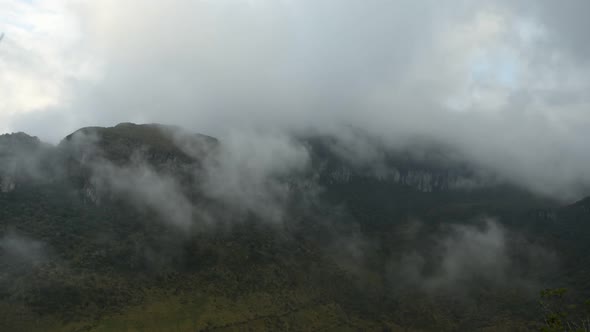 Time lapse of low clouds moving over mountains alt