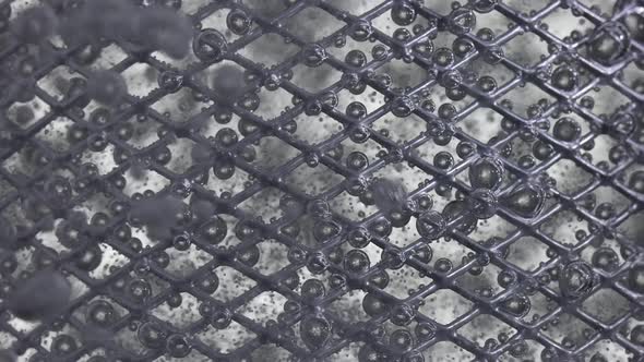 The Flow of Water Directed to the Metal Mesh Causes the Bubbling of Oxygen Bubbles alt