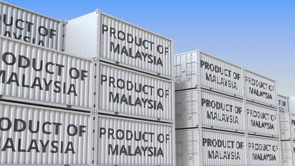 Containers with PRODUCT OF MALAYSIA Text in a Container Terminal alt