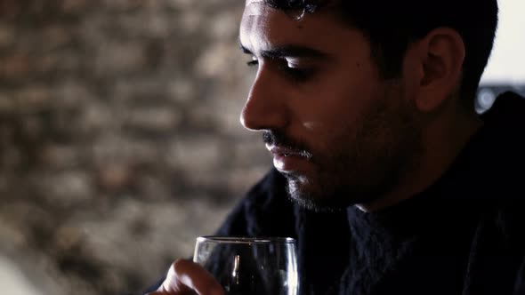 Stressed Thoughtful Young Man Drinking Alone in A Pub alt