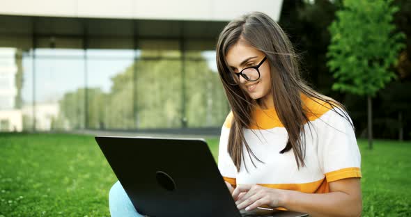 Woman with Laptop Working Outdoors