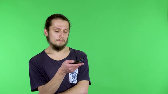 A Man with a TV Remote Control in His Hand Who Changes Channels Stops at Interesting Then Looks at alt