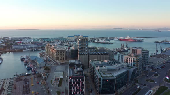 Cape Town harbor and Waterfront during golden hour while the sun sets.