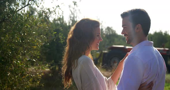 Romantic couple embracing each other in olive farm 4k alt