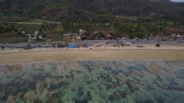 This was the undeveloped and almost natural beach in 2017.Calmer aerial view flight fly backwards d alt