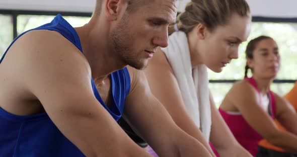 Working out on exercise bikes at a gym alt