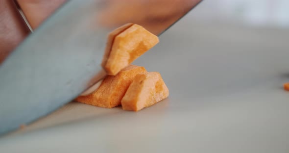 Cutting Carrot with Big Knife Closeup