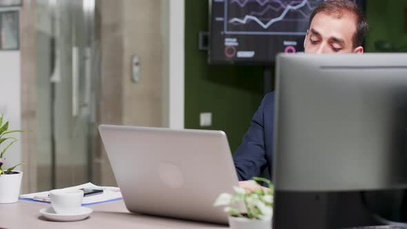 Dolly Shot of Young Director in Modern Office Leaving the Workplace alt