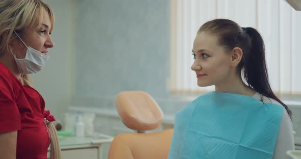 Beautiful Woman Doctor Talks to the Patient Makes Recommendations alt