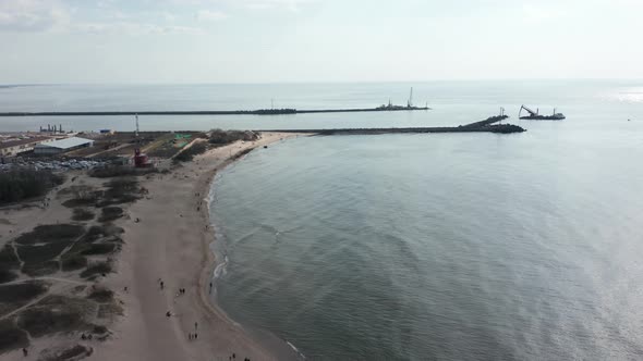 AERIAL: Klaipeda Port near Melnrage Beach on a Cloudy Day with Calm Baltic Sea