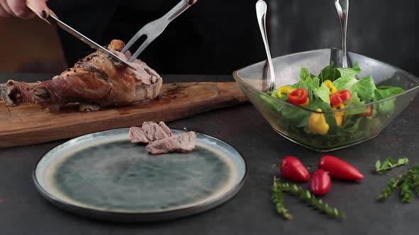 Woman cutting roasted turkey leg