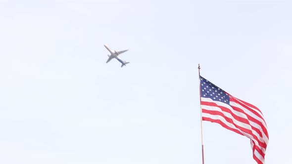 Plane Flying in Sky American Flag Waving California USA