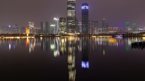 Shenzhen Urban Cityscape China Timelapse at Night with Reflection in Water Pan Up alt
