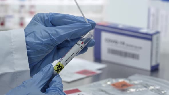 Coronavirus swab test being sealed in vile and plastic bag alt