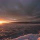 Sun setting over frozen lake as sky lights up with vibrant colors - VideoHive Item for Sale