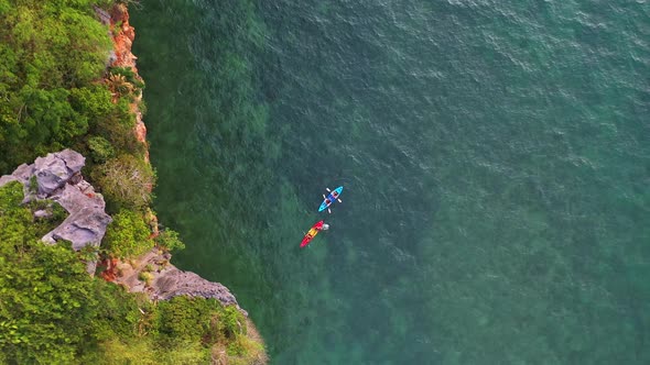 4K Aerial view of Young Asian man and woman friends kayaking together in the sea on summer vacation. alt