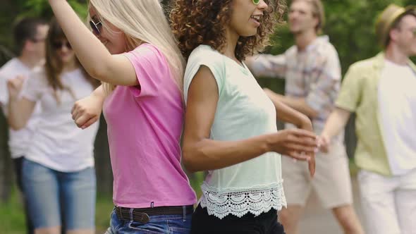 Two Attractive Women Performing Sexy Dance Back to Back, Young People Partying alt