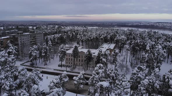 Aerial View of an Old Soviet School in a Small Town on a Winter Day alt