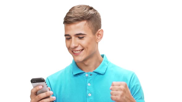 Happy Young Handsome Man Looking at Phone Over White Background Slow Motion
