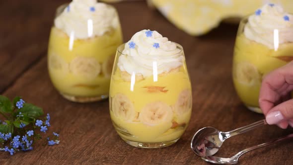 Glass with Delicious Banana Pudding on Table