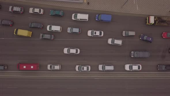 Lowangle Drone Flight Over a Massive Intersection During Early Evening Rush Hour with Cyclists