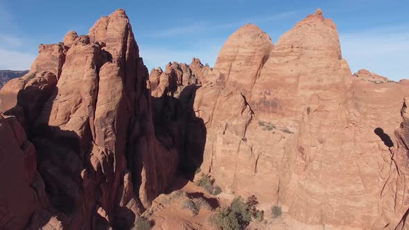 Aerial view flying through rock fins in Moab Utah alt