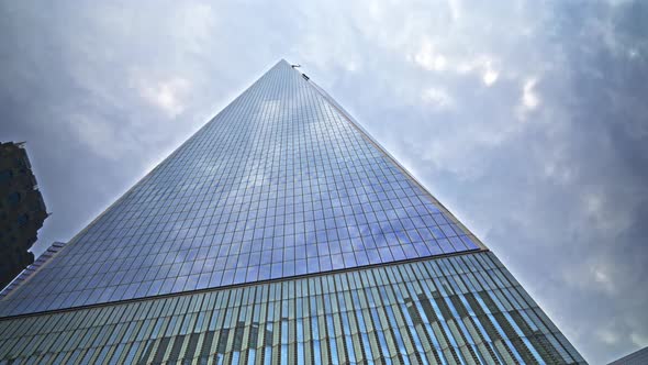 One World Trade Centre Reflecting Cloudy Sky In New York City alt