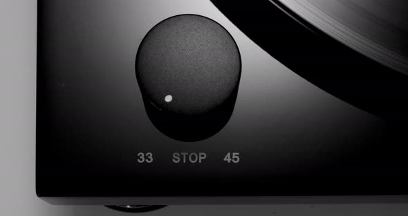 Control Knob on Turntable with Spinning Vinyl Record on alt