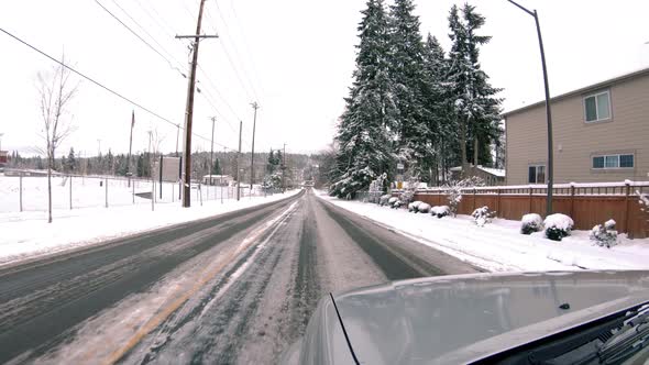 Driving Perspective On Ice In Snow Covered Residential Neighborhood alt