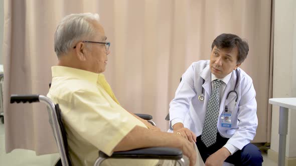 Orthopedist examines the knee of elderly patient to collect information for physical therapy treated alt