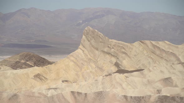 Pan right of dunes and peaks in Death Valley alt