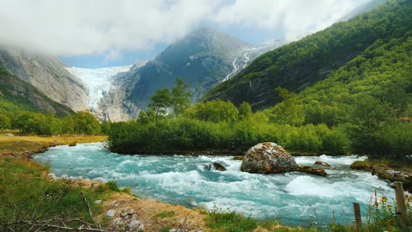 Wide Lens Shot: Briksdal Glacier with a Mountain River in the Foreground. The Amazing Nature of alt
