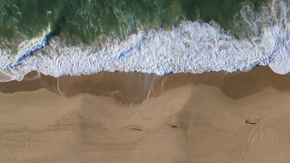 Aerial View of Waves Crashing Into Shoreline
