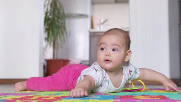 Portrait of a Nice Newborn Baby  Lying on His Stomach Looking Interestingly at Camera alt