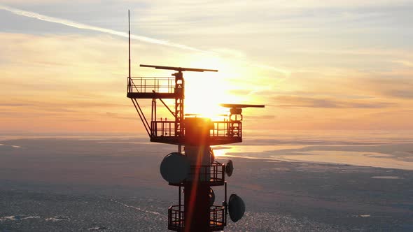 Upper Ground of Communication Tower Illuminated By Sunset alt