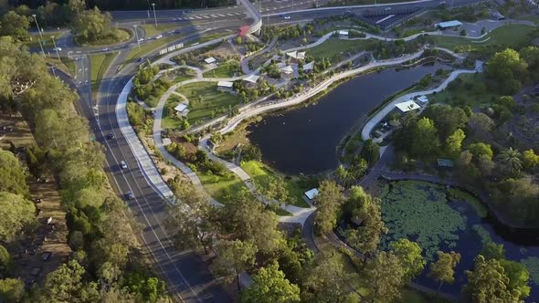 Aerial shot of roads surrounding a large pond alt