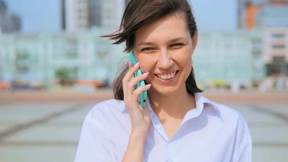 Close Up Portrait Happy Cheerful Woman Laughing Using Cellphone Urban City Background alt