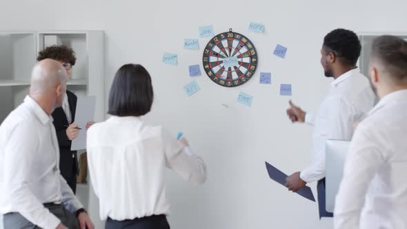 Woman Throwing Darts at Motivational Words alt
