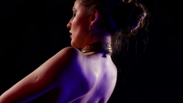 Sexual Halfnaked Dancer is Moving Slowly in Darkness Rear View on Naked Shoulders alt